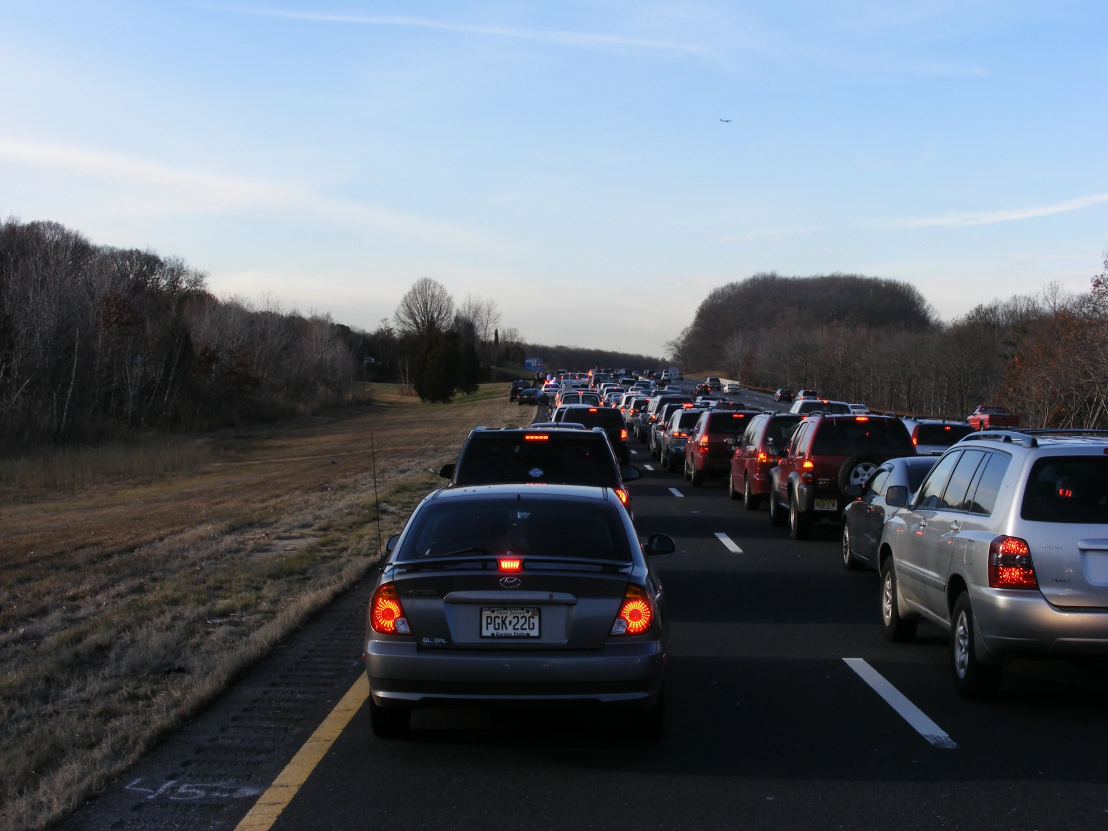 cars are driving down a busy highway in the daytime