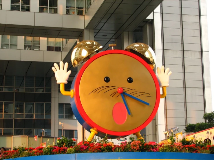 a clock shaped like a cat that is in the air