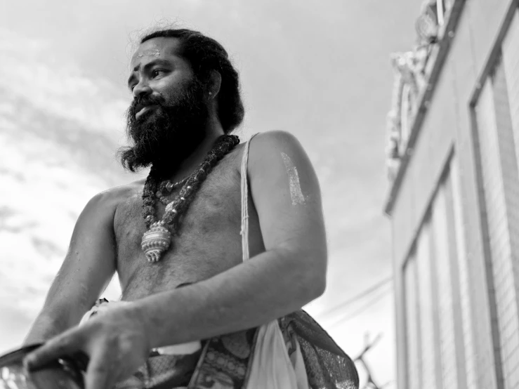 a man wearing  carrying a bag with a big beard