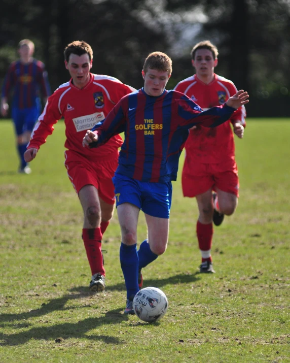 several s play soccer on a green field