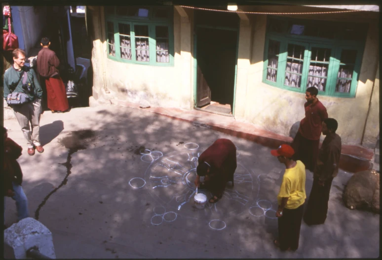 a group of people are playing with chalk