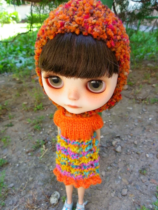 a doll with a hat and scarf wearing shoes