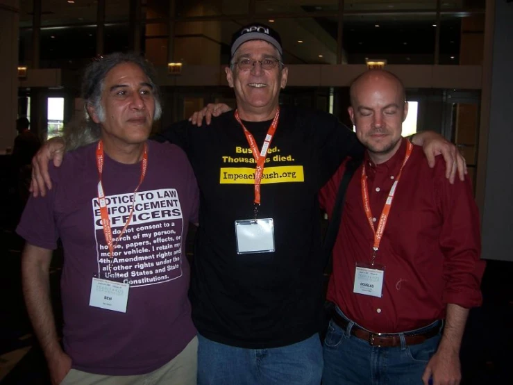 three men are posing for the camera with their arms around each other