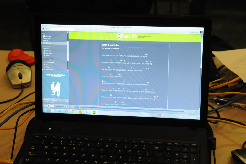 an open laptop computer sitting on top of a wooden desk