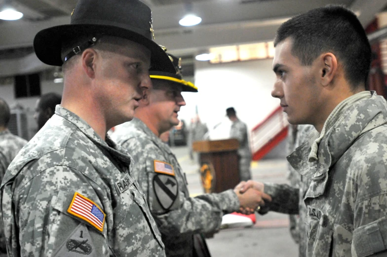 three soldiers shaking hands next to each other