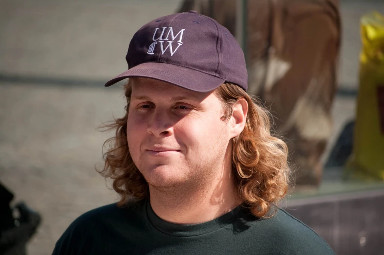 a woman wearing a hat while staring at soing