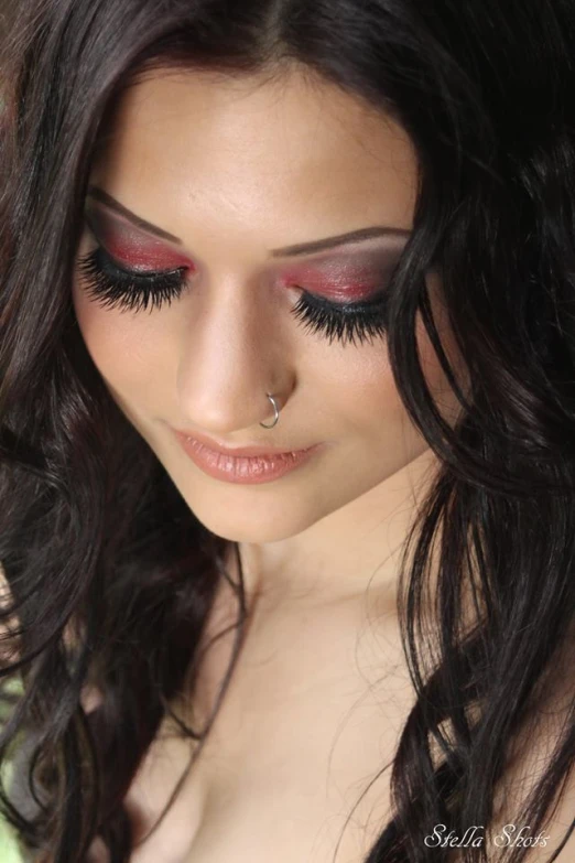 woman wearing wedding makeup and holding flowers with long hair