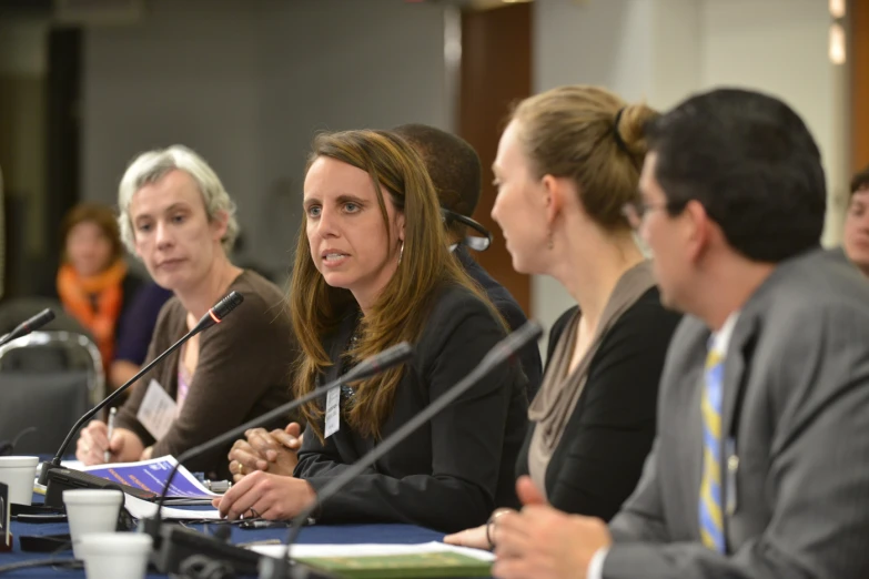 three women and a man at a meeting