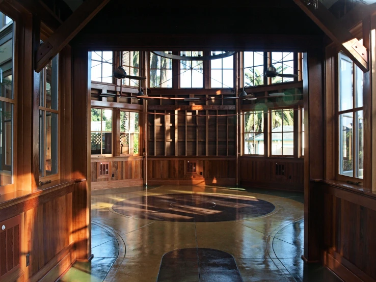 a room with windows and a wooden paneling in it