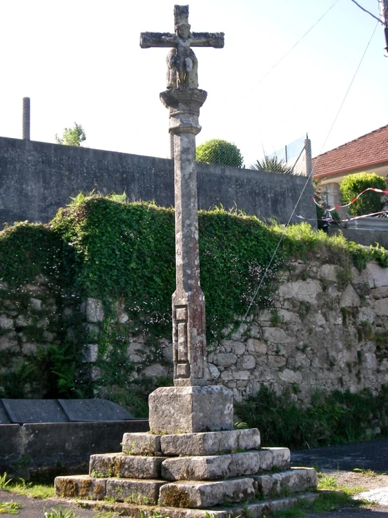 a cross on top of a small set of stone steps