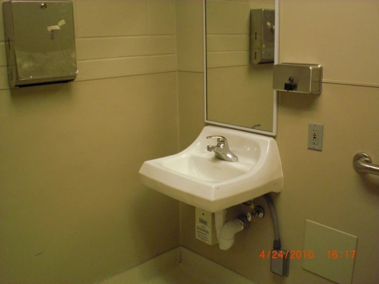a bathroom sink is shown in the corner with a mirror