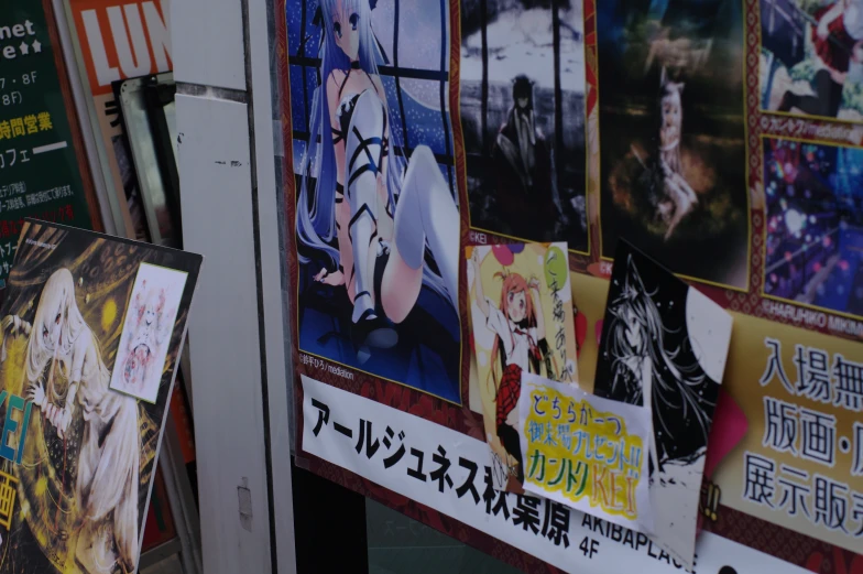 posters hanging on the wall with japanese characters