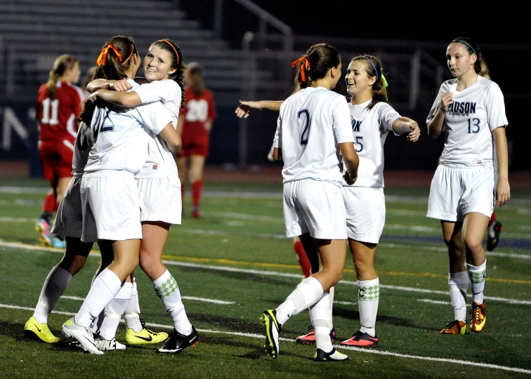 a soccer team is huddled around the player's head