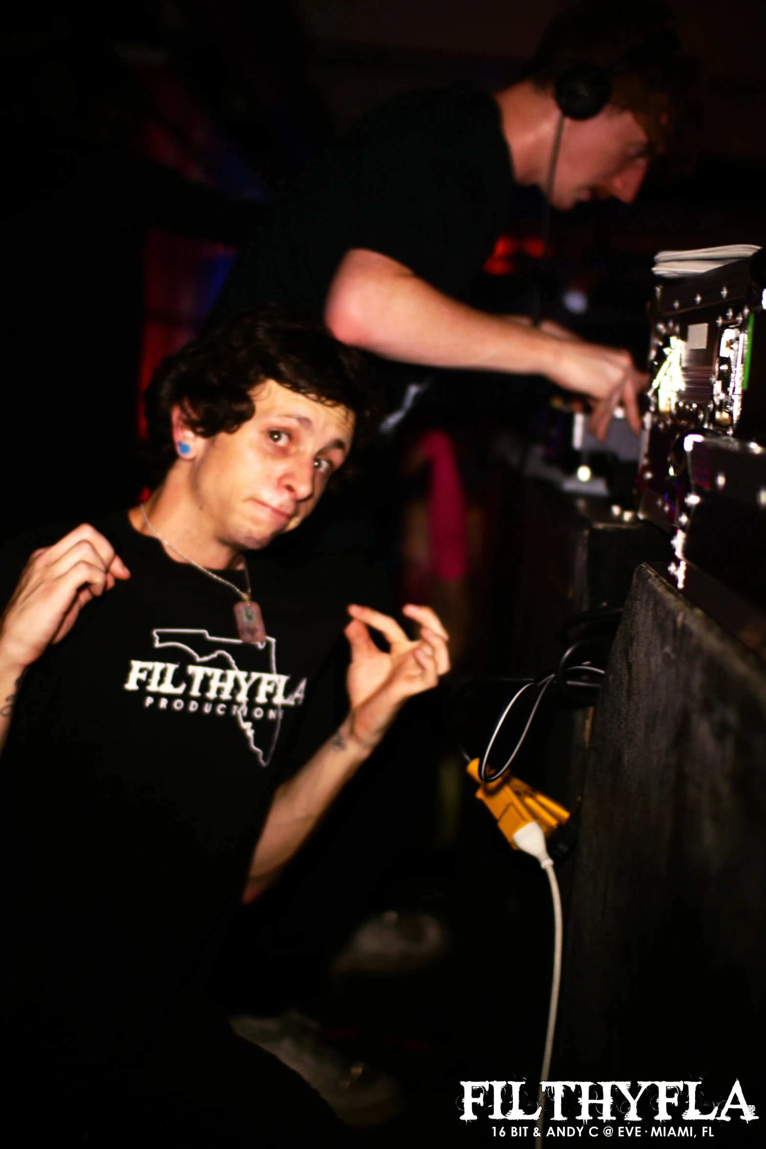 a man standing next to another person behind a bar