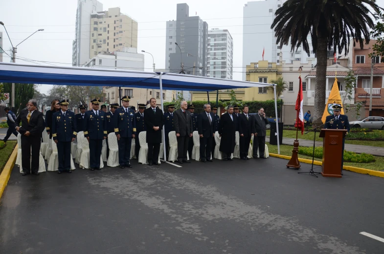 a group of men in blue and white suits stand at a podium