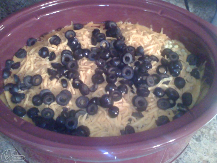 a pot filled with pasta and olives