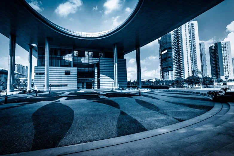 an open walkway under a circular building in a city