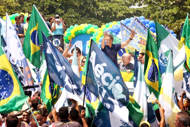 many people holding up flags in front of a building