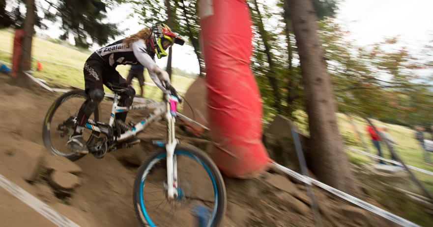 a downhill bike rider rides on a trail