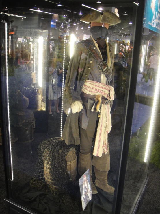 a man in a pirates uniform and a hat standing in front of a mirror