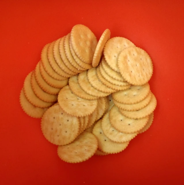 a pile of ers stacked on a red surface