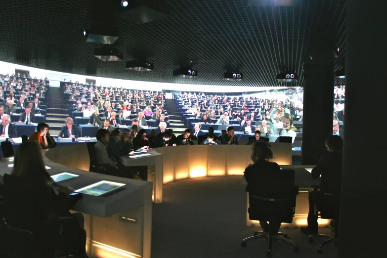 people sitting in front of tables in a meeting room