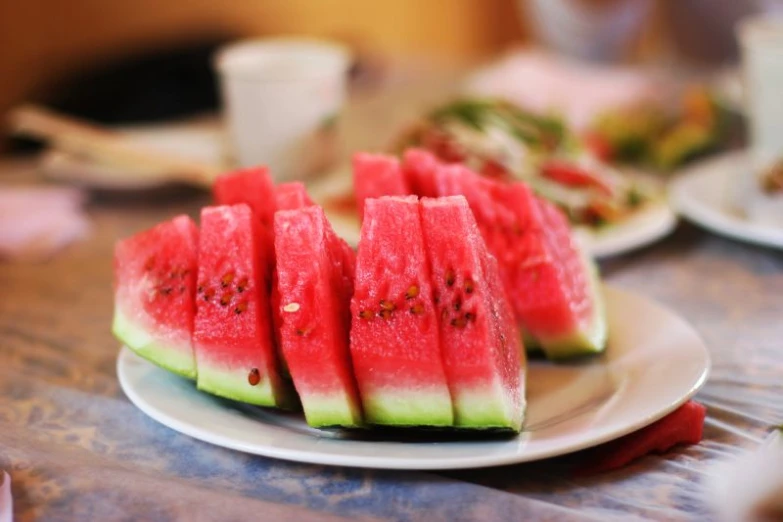 sliced up slices of watermelon sitting on top of a plate