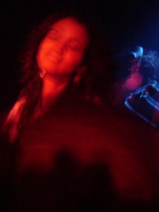 a black woman in a red light with blue and red lights