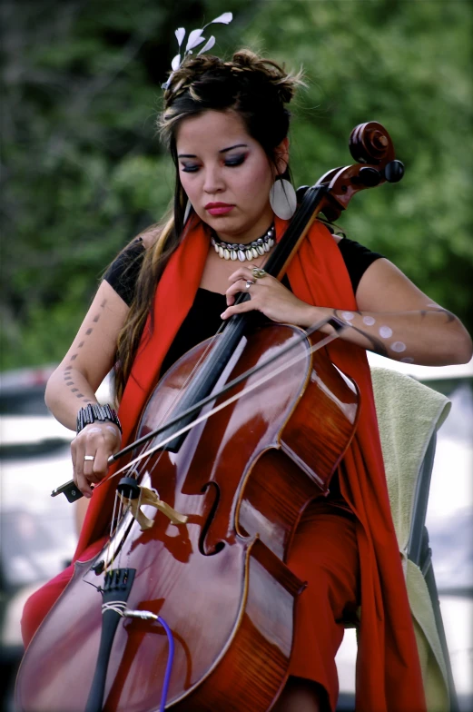 a young woman plays an instrument in a red dress