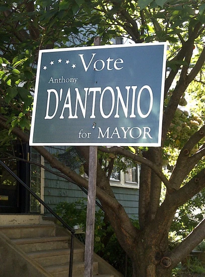 a sign outside of a house reads vote in a language called dantonio for mayor