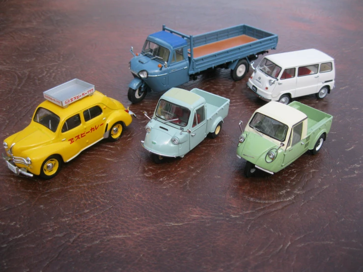 four toy cars in a line up and on display