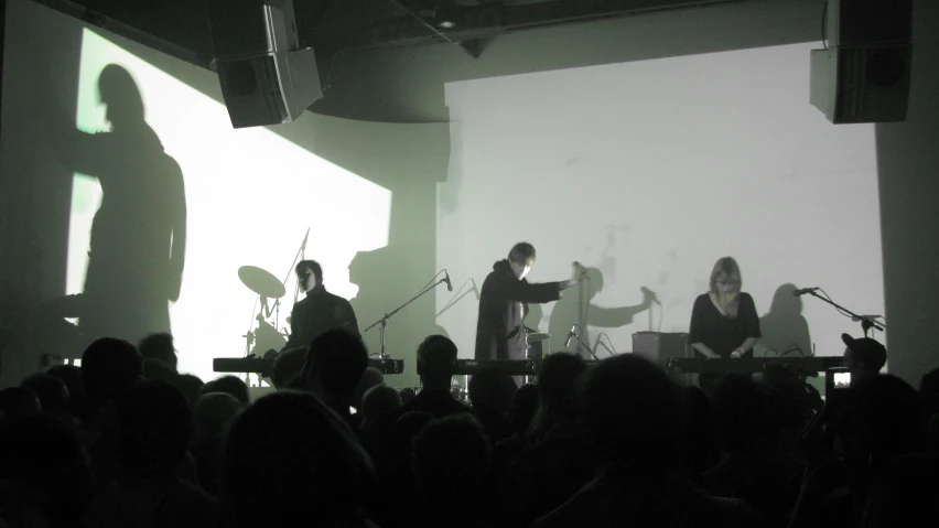 a group of people on a stage in front of a crowd