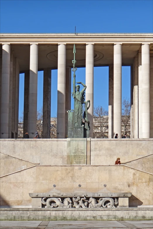 there is a statue near a building in front of it