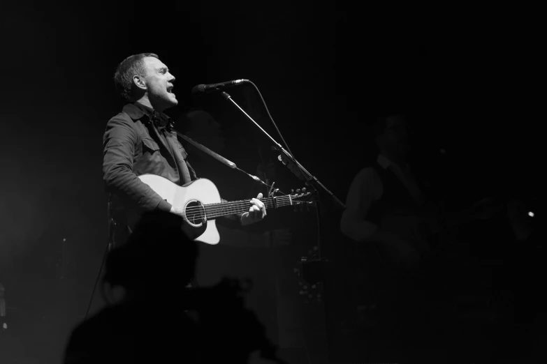 black and white image of a man with a guitar