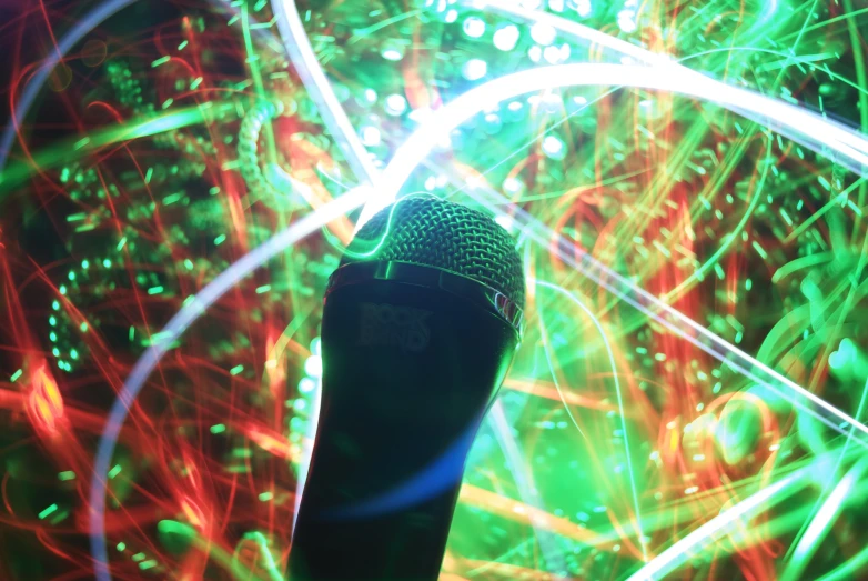 a microphone is shown in front of colorful lights