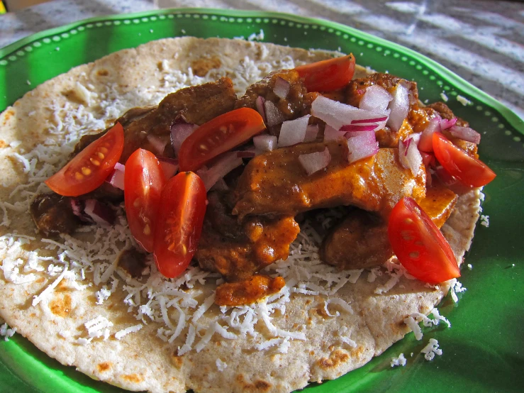 a meal with meat and peppers served on a tortilla