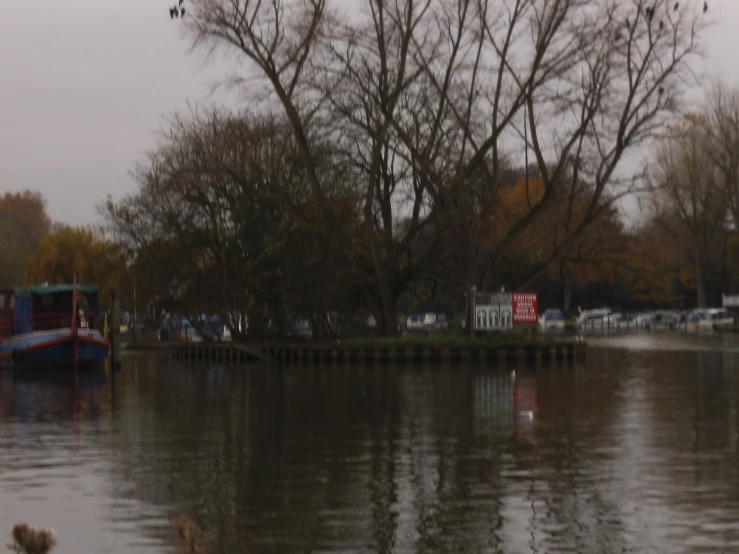 a river with some trees and a large boat in the water