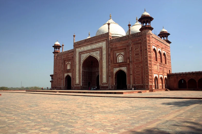 the old building is built of brick and has many domes on top