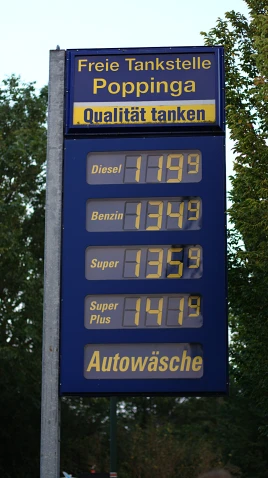 a blue gas station sign with digital numbers