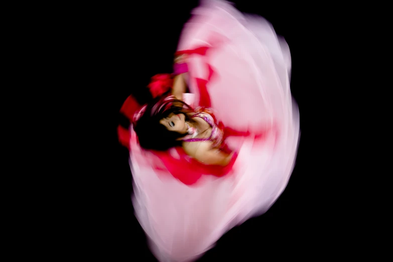 a person with their arm extended is standing in front of a flower