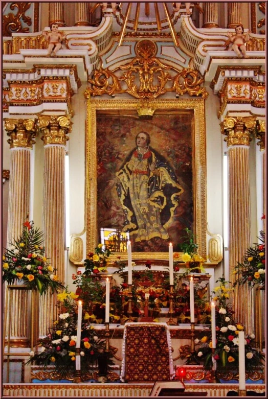 an alter with a golden and white painting on it