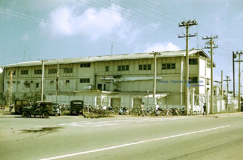 an old, white building sitting next to a city street