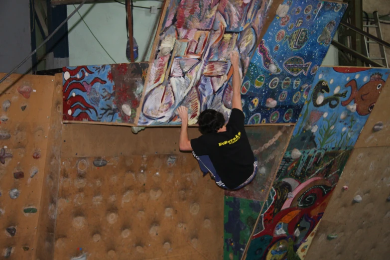 a man skateboarding and climbing on a wall