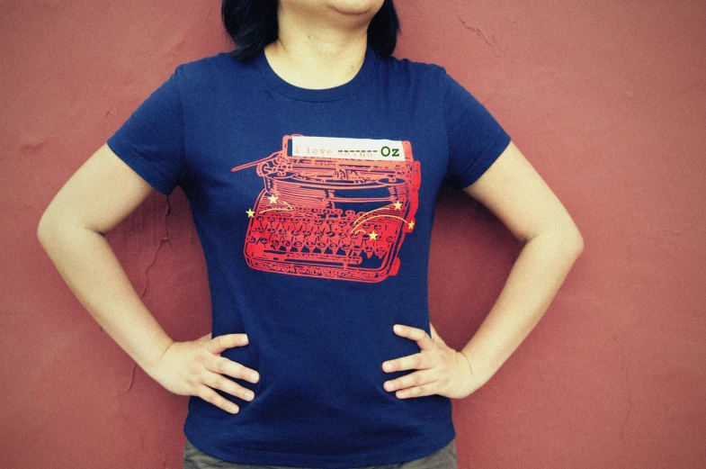 a woman standing in front of a red wall