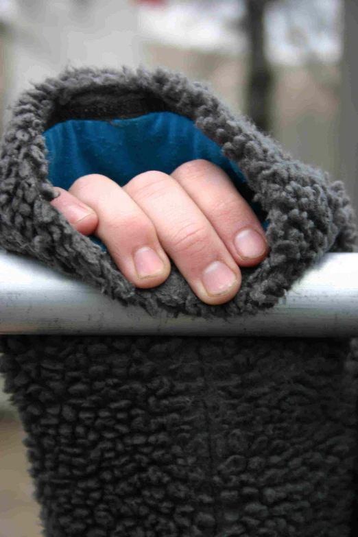 the hands on top of a bench touching together