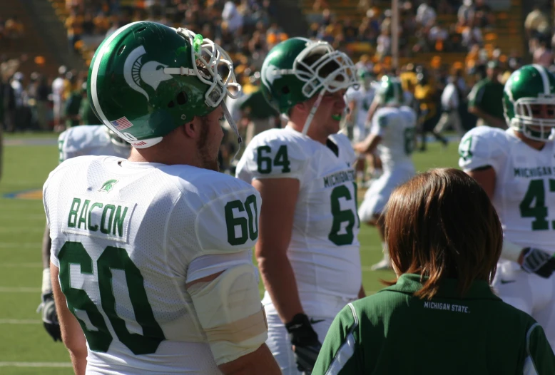 a team of football players stand together in a line