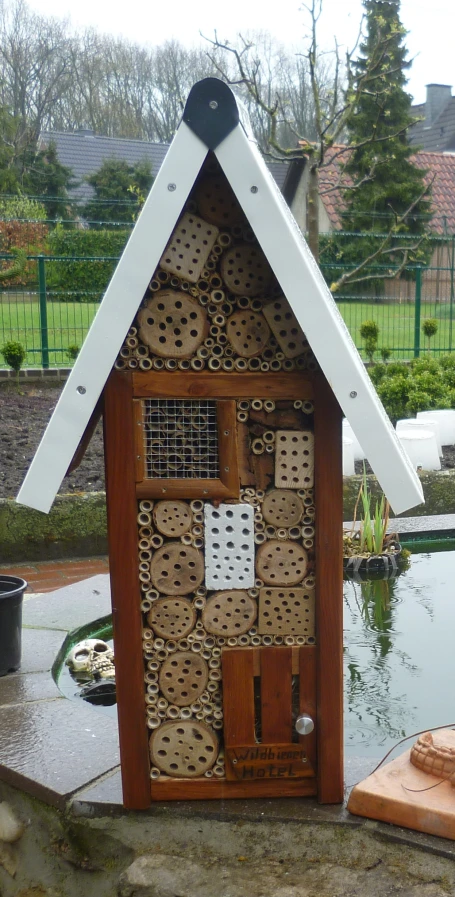 an image of a bird house that is built out of sticks and rocks