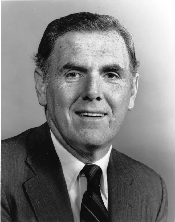 black and white pograph of a man in suit with a tie