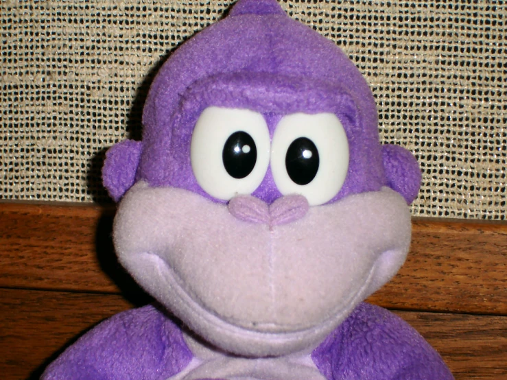 a close - up of a stuffed animal monkey on a table