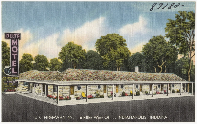 an old picture of the front of a motel with trees and clouds in background